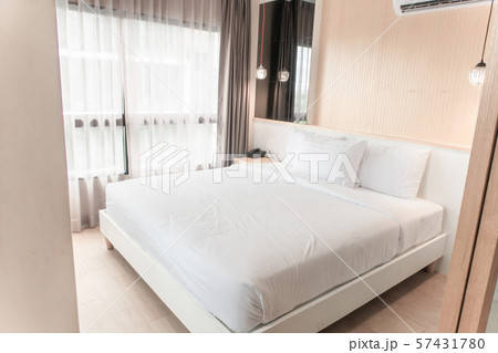 The white twin bed is set in a wood and pastel 57431780