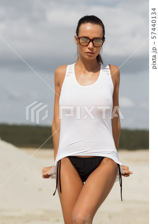 Pretty female in beachwear on nature background Pretty female in beachwear on nature background 57440134