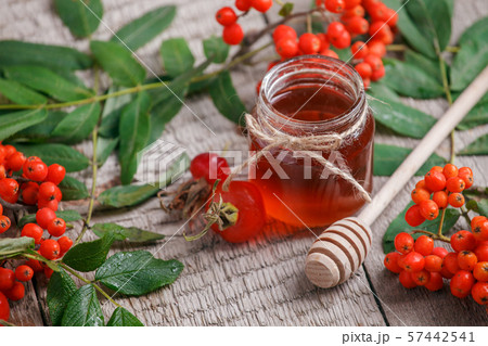 Fresh rose hip berries, rowan and honey on wooden 57442541
