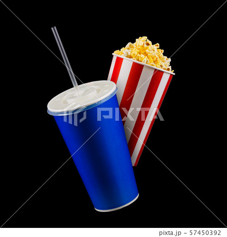 Paper striped bucket with popcorn and cup of soft drink isolated on black 57450392