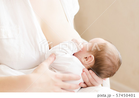 Young mom breastfeeding her little baby boy. 57450401