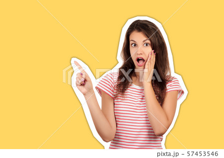 Studio shot of surprised attractive woman pointing Studio shot of surprised attractive woman pointing 57453546