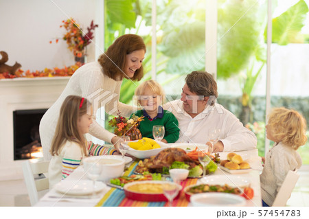 Family with kids at Thanksgiving dinner. Turkey. Family with kids at Thanksgiving dinner. Turkey. 57454783