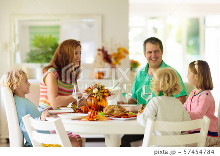 Family with kids at Thanksgiving dinner. Turkey. 57454784