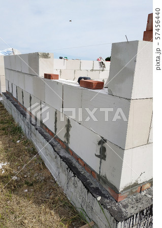 Laying the wall of gas blocks with tools and glue. 57456440