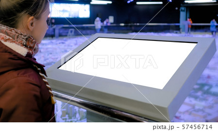 White screen concept - woman looking at blank white display kiosk at exhibition White screen concept - woman looking at blank white display kiosk at exhibition 57456714