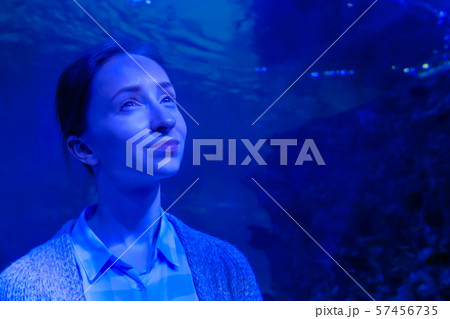 Woman looking at fish in large public aquarium tank at Oceanarium Woman looking at fish in large public aquarium tank at Oceanarium 57456735
