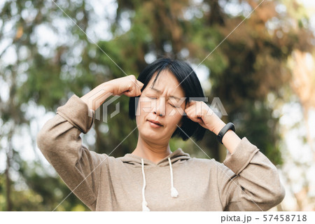 mature Asian woman have headache 57458718