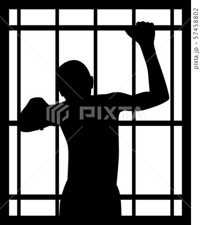 Man in prison behind bars 57458802