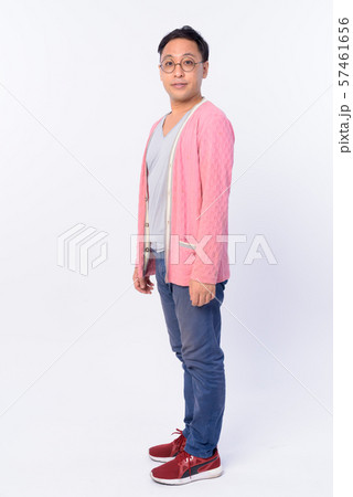 Full body shot profile view of Japanese man looking at camera 57461656