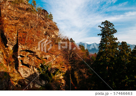 Rock cliff autumn forest and blue sky at Yamadera 57466663