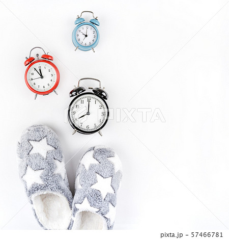 Soft fluffy slippers and alarm clocks 57466781