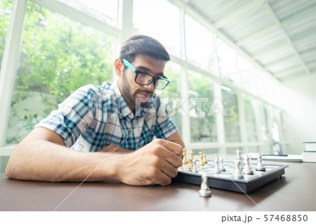 Casual businessman playing chess game with retro Casual businessman playing chess game with retro 57468850