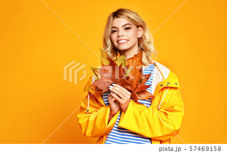 happy emotional girl with autumn leaves on colored 57469158