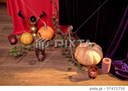 Autumn floral bouquet in a copper vase on a wooden floor decorated with pumpkins for Halloween Autumn floral bouquet in a copper vase on a wooden floor decorated with pumpkins for Halloween 57471750