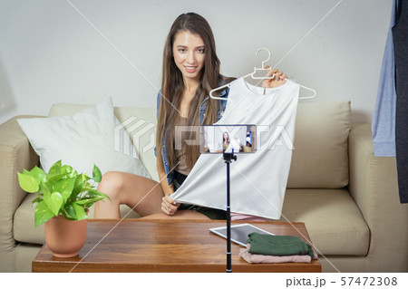Young girl selling clothes online by live Young girl selling clothes online by live 57472308
