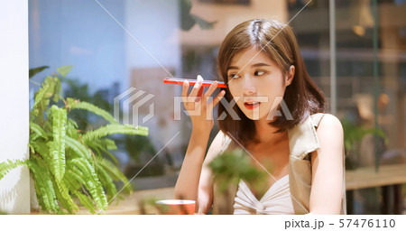 Young woman listen to voicemail Young woman listen to voicemail 57476110