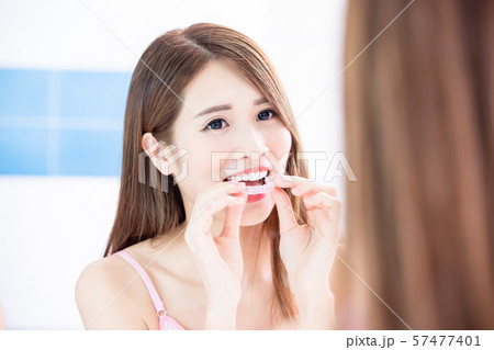 woman use invisible braces woman use invisible braces 57477401