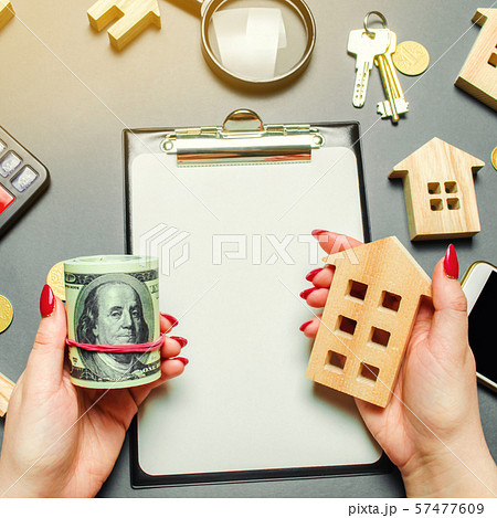 A girl holds in his hands a dollars A girl holds in his hands a dollars 57477609