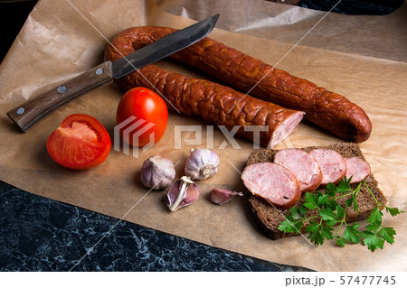 Slices of smoked sausage with spice, herbs and Slices of smoked sausage with spice, herbs and 57477745