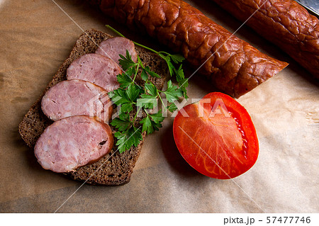 Slices of smoked sausage with spice, herbs and Slices of smoked sausage with spice, herbs and 57477746