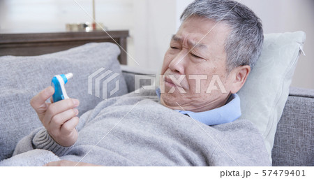 asian eldely man use thermometer 57479401