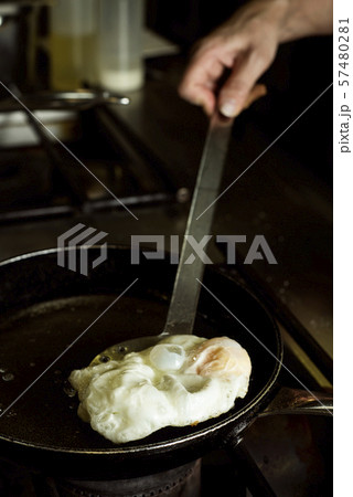 frying an egg in a professional kitchen 57480281