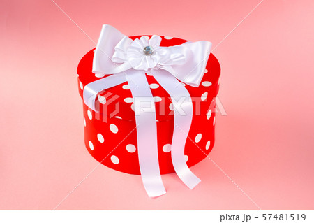 Gift box with colored ribbon isolated on a pink Gift box with colored ribbon isolated on a pink 57481519
