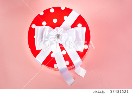 Gift box with colored ribbon isolated on a pink Gift box with colored ribbon isolated on a pink 57481521
