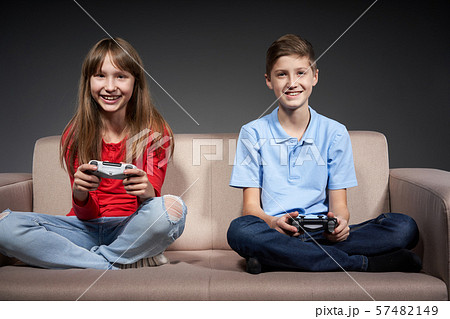 Computer game competition. Gaming concept. Excited girl playing video game with joystick Computer game competition. Gaming concept. Excited girl playing video game with joystick 57482149