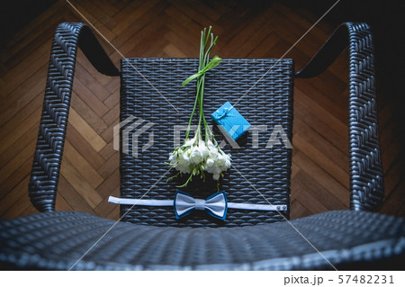 The groom is gathering in the morning. Wedding bouquet, handkerchief butterfly and gift box on the The groom is gathering in the morning. Wedding bouquet, handkerchief butterfly and gift box on the 57482231