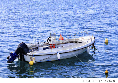 A motor boat is anchored in the clear waters A motor boat is anchored in the clear waters 57482826