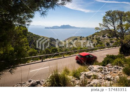 Road to Cap Formentor with red motion blurred car Road to Cap Formentor with red motion blurred car 57483351