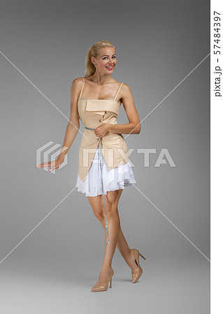 beautiful slim blond woman holding centimeter measuring 57484397