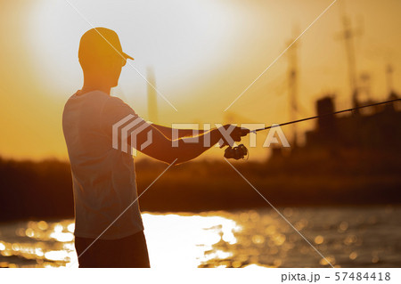 Young man fishing at sea 57484418