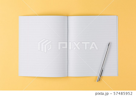 notebook with black pen on yellow background 57485952