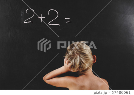 little boy without T-shirt thinks on blackboard 57486061