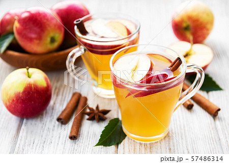Apple cider with cinnamon sticks Apple cider with cinnamon sticks 57486314