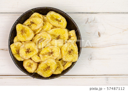 Yellow dry banana on grey wood Yellow dry banana on grey wood 57487112