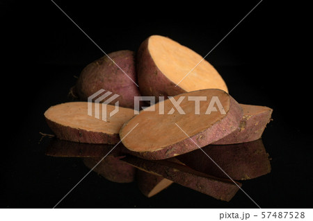 Fresh sweet potato isolated on black glass Fresh sweet potato isolated on black glass 57487528