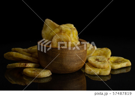 Yellow dry banana isolated on black glass Yellow dry banana isolated on black glass 57487819