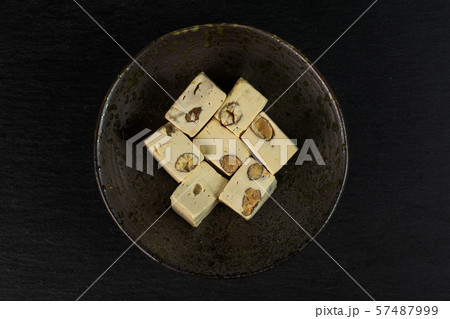 White nougat candy on grey stone White nougat candy on grey stone 57487999