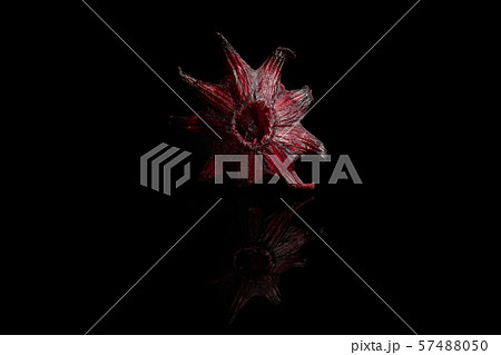 Candied hibiscus isolated on black glass Candied hibiscus isolated on black glass 57488050