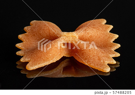 Raw farfalle tricolore isolated on black glass 57488205
