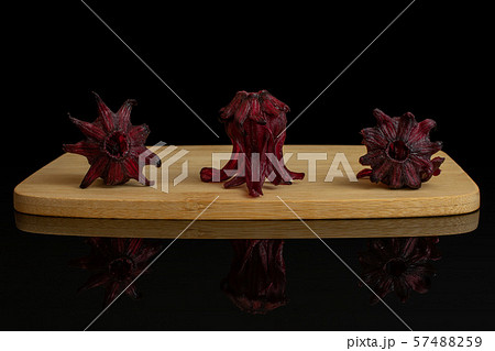 Candied hibiscus isolated on black glass 57488259