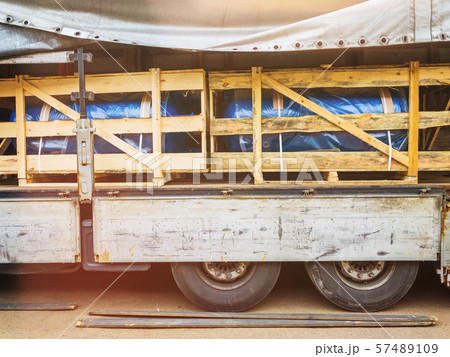 Heat and power equipment transportation with lens flare. Forklift unloads a cargo trailer. 57489109