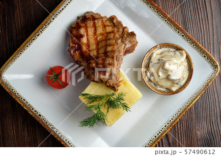 Steak on the bone with red sauce. restaurant menu Steak on the bone with red sauce. restaurant menu 57490612