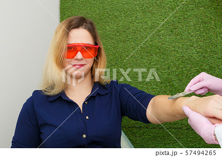 A young woman is preparing for laser hair removal. A young woman is preparing for laser hair removal. 57494265