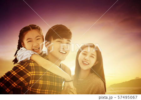 happy family standing and watching the sunset 57495067