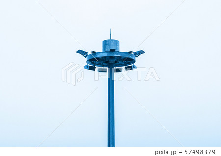Spotlight pole with pale white sky background Spotlight pole with pale white sky background 57498379